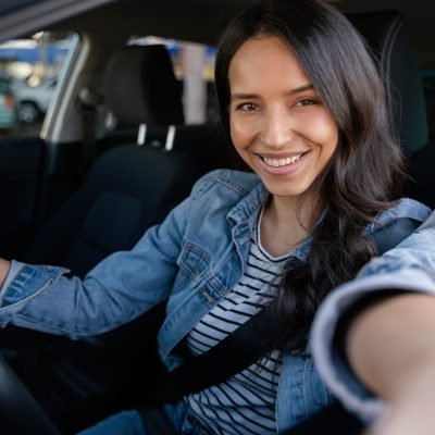 brunette-woman-taking-selfie-her-car-1.jpg
