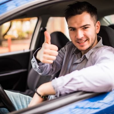 happy-smiling-man-sitting-inside-car-showing-thumbs-up-handsome-guy-excited-about-his-new-vehicle-positive-face-expression-1.jpg